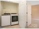 Laundry room with washer, dryer, and storage shelf, ready for convenience at 349 Valley Brook Se Ln, Concord, NC 28025