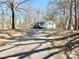 Exterior view of the home with a long driveway and mature trees at 3980 Linda Dr, Rock Hill, SC 29730