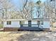 Charming single-story home with a blue exterior, gray painted brick, and front porch at 3980 Linda Dr, Rock Hill, SC 29730