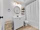 Bright bathroom with modern vanity, round mirror, decorative basket and tub-shower combo at 4022 Carl Parmer Dr, Harrisburg, NC 28075