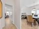 Open-concept dining room with wood floors, modern lighting, and seating area in a bright and airy space at 4022 Carl Parmer Dr, Harrisburg, NC 28075