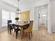 Spacious dining room featuring modern lighting and decor, with hardwood floors at 4022 Carl Parmer Dr, Harrisburg, NC 28075