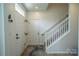 Bright foyer with light floors, white walls, coat hooks, and staircase with white railing at 4022 Carl Parmer Dr, Harrisburg, NC 28075