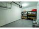Well-lit garage with shelving and storage, providing ample space for organization and parking at 4022 Carl Parmer Dr, Harrisburg, NC 28075