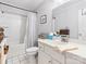 Well-lit bathroom featuring a single vanity, toilet, tub, and shower combo with tiled floors at 405 Wilson N St, Rock Hill, SC 29730