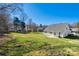 Expansive backyard with green grass and view of house and surrounding trees at 4103 Belle Meade Cir, Belmont, NC 28012