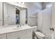 Clean, minimalist bathroom with a white vanity, toilet, and shower with a patterned curtain at 4103 Belle Meade Cir, Belmont, NC 28012