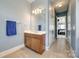 Hall bathroom with a single sink vanity, tiled floors, and modern fixtures at 4103 Belle Meade Cir, Belmont, NC 28012