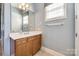 Well-lit bathroom features a single vanity with a window and ceramic tile flooring at 4103 Belle Meade Cir, Belmont, NC 28012
