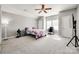 Bright bedroom with a ceiling fan, carpeted floor, and a well-lit study area at 4103 Belle Meade Cir, Belmont, NC 28012