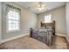Cozy bedroom with a rustic wooden bed frame and natural light from two windows at 4103 Belle Meade Cir, Belmont, NC 28012
