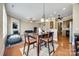 Open dining area with views of the kitchen and living room, featuring a table and modern lighting at 4103 Belle Meade Cir, Belmont, NC 28012