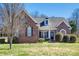 Charming brick home with a manicured lawn, inviting curb appeal and beautiful architectural details at 4103 Belle Meade Cir, Belmont, NC 28012