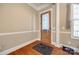 Entryway featuring hardwood floors, decorative molding, and a stylish wooden door at 4103 Belle Meade Cir, Belmont, NC 28012