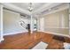 Open-concept living area featuring hardwood floors and elegant columns, a staircase, and a neutral color scheme at 4103 Belle Meade Cir, Belmont, NC 28012