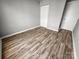 Cozy bedroom with hardwood floors and a double door closet at 4824 Spring Lake Dr # E, Charlotte, NC 28212