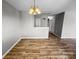 Inviting dining room featuring hardwood floors and a modern chandelier at 4824 Spring Lake Dr # E, Charlotte, NC 28212