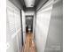 Hallway area with closet space leading to the bathroom at 4824 Spring Lake Dr # E, Charlotte, NC 28212