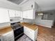 Well-equipped kitchen featuring an electric range, ample cabinet space, and wood countertops at 4824 Spring Lake Dr # E, Charlotte, NC 28212
