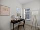 Bright office space with desk, chair, and natural light from two windows at 5013 Cherry Gum Ct, Matthews, NC 28105