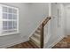 Carpeted staircase with white risers and wood railing leading to upper level at 5013 Cherry Gum Ct, Matthews, NC 28105