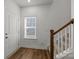 Bright entryway featuring wood-look flooring and a staircase leading to the upper level at 5021 Cherry Gum Ct, Matthews, NC 28105