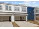 Two-car garage with modern overhead doors, providing ample space for vehicles and storage at 5021 Cherry Gum Ct, Matthews, NC 28105