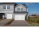 Charming two-story townhome featuring a two-car garage and neutral color palette at 5021 Kellaher Pl, Charlotte, NC 28216