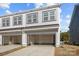 Townhome featuring spacious two car garage with an automatic door and ample parking at 5025 Cherry Gum Ct # 47, Matthews, NC 28105