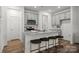 Modern kitchen featuring an island with seating, granite countertops, and stainless steel appliances at 5025 Cherry Gum Ct # 47, Matthews, NC 28105