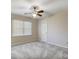 Bedroom featuring neutral walls, carpet flooring, a ceiling fan, a window with blinds and a closet door at 6038 Burnt Mill Run, Matthews, NC 28104