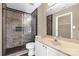 Bathroom with tiled shower and glass door, plus a vanity with mirror and a view into the closet at 605 Gable Dr, Rock Hill, SC 29732