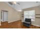 Neutral bedroom featuring hardwood floors, a ceiling fan, and a cozy chair near a large window at 605 Gable Dr, Rock Hill, SC 29732