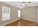Neutral bedroom features wood-look floors, a ceiling fan, and bright windows with white trim at 605 Gable Dr, Rock Hill, SC 29732