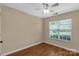 Bedroom featuring wood-look floors, a ceiling fan, a bright window and neutral-colored walls at 605 Gable Dr, Rock Hill, SC 29732