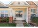 Cozy front porch with brick accents, inviting entrance, and well-maintained landscaping at 605 Gable Dr, Rock Hill, SC 29732