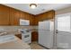 Kitchen features white appliances, wooden cabinets, and neutral countertops at 605 Gable Dr, Rock Hill, SC 29732