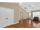 Spacious living room features hardwood floors, neutral paint, vaulted ceilings, and large windows with a cozy chair at 605 Gable Dr, Rock Hill, SC 29732