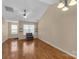 Bright living room with natural light, hardwood floors, vaulted ceiling and fan, and a cozy seating area at 605 Gable Dr, Rock Hill, SC 29732