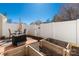 Cozy patio area featuring a white fence, garden bed, outdoor table with an umbrella, and garden boxes at 605 Gable Dr, Rock Hill, SC 29732