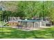 Backyard pool with deck, railing, hot tub, seating, and greenery at 6349 Lebanon Rd, Mint Hill, NC 28227