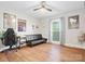 Spacious bedroom features hardwood floors, modern furnishings, a ceiling fan, and lots of natural light at 6349 Lebanon Rd, Mint Hill, NC 28227
