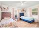Unique bedroom features matching beds, hardwood floors, polka dot wall decor, and lots of natural light at 6349 Lebanon Rd, Mint Hill, NC 28227