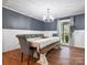 Bright dining room featuring hardwood floors, a modern chandelier, and a stylish dining table at 6349 Lebanon Rd, Mint Hill, NC 28227