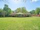 Charming one-story brick home featuring a covered front porch and a lush green lawn at 6349 Lebanon Rd, Mint Hill, NC 28227