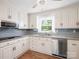 Charming kitchen with white cabinets, granite countertops, stainless steel appliances, and decorative tile backsplash at 6349 Lebanon Rd, Mint Hill, NC 28227