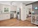Bright kitchen features stainless steel appliances, white cabinetry, granite counters, and hardwood floors at 6349 Lebanon Rd, Mint Hill, NC 28227