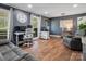 Comfortable living room featuring hardwood floors, modern decor, and a large window with natural light at 6349 Lebanon Rd, Mint Hill, NC 28227
