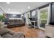 Spacious living room with hardwood floors, gray walls, large windows, and comfortable seating at 6349 Lebanon Rd, Mint Hill, NC 28227