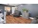 Cozy living room featuring hardwood floors, gray walls, modern decor, and comfortable furnishings at 6349 Lebanon Rd, Mint Hill, NC 28227